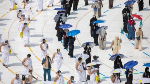 Muslim pilgrims maintain social distancing as they circle the Kaaba at the Grand mosque during the annual Haj pilgrimage, 29 July 2020