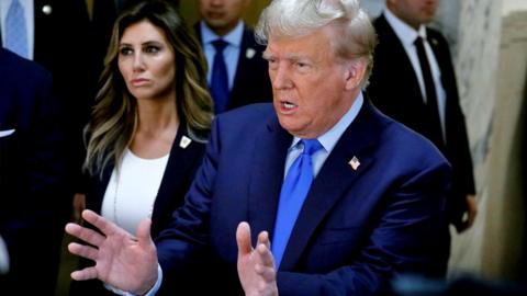 Former US President Donald J. Trump speaks to the media before he attends the first day of his civil fraud trial in New York, New York, USA, on 2 October 2023