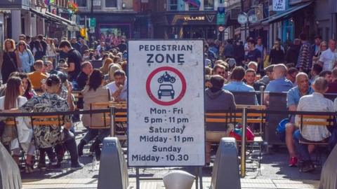 Outdoor diners on a sunny summer's day in Soho