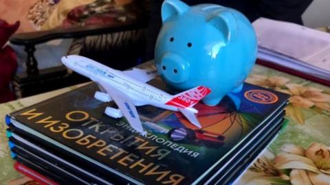 Encyclopaedias and a piggy bank were among the items an 8-year-old boy set off with to travel the world