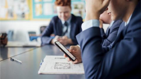 Pupil using a mobile phone