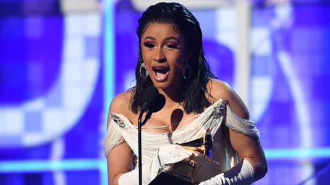 Cardi B collecting her Grammy Award on stage in 2019