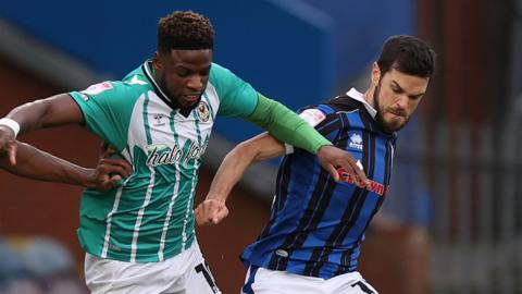 Offrande Zanzala of Newport County tries to run through Jimmy Keohane of Rochdale