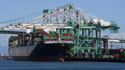 In this file photo taken on February 16, 2019 shipping containers from China and other nations are unloaded at the Long Beach Port in Los Angeles, California.