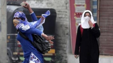 A Kashmiri female student throws a rock on police during clashes in Srinagar, the summer capital of Indian Kashmir, 24 April 2016