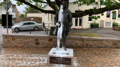 White paint on face and body of George Carteret statue