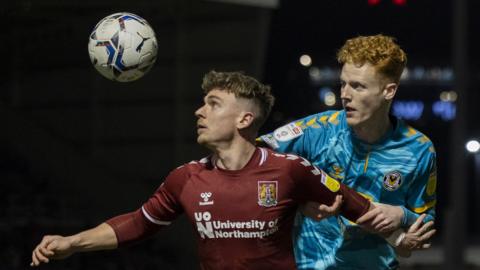 Newport County's Ryan Haynes loses the ball to Sam Hoskins of Northampton Town
