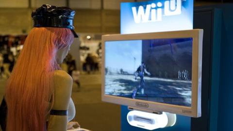 A gamer plays a Wii U