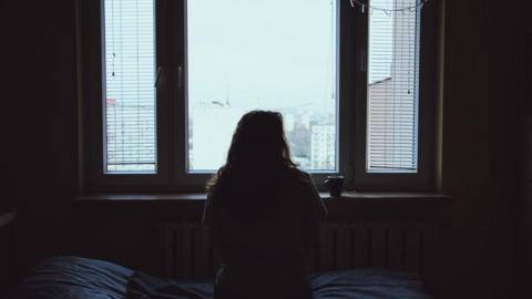 Woman looking out of a window