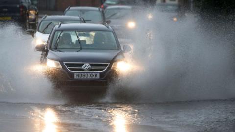 A car goes through a puddle