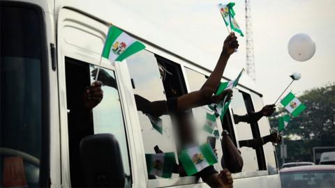 Protesters waving Nigerian flags