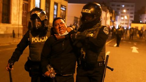 A demonstrator is detained by police officers during a protest demanding the dissolution of Congress and to hold democratic elections rather than recognize Dina Boluarte as Peru's President, after the ouster of Peruvian leader Pedro Castillo, in Lima, Peru December 11, 2022