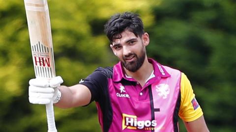 Andy Umeed raises his bat