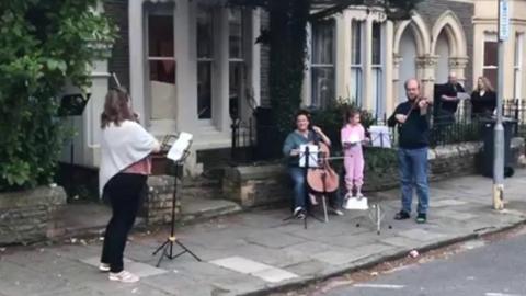 people playing instruments in street