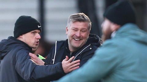 Salford City boss Karl Robinson talks to the fourth official after his sending off against Forest Green Rovers