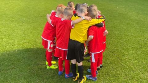 Cliftonville's future stars have a huddle on the pitch at West Brom