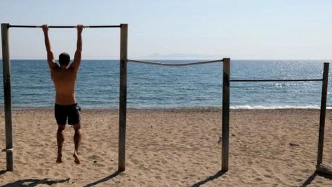 A man exercises on a beach, following the coronavirus disease (COVID-19) outbreak, in Athens, Greece, April 28, 2020