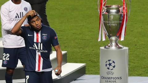 Kylian Mbappe and the Champions League trophy