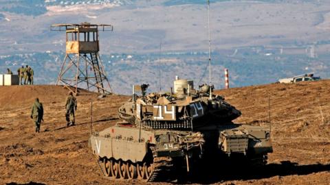 File photo showing Israeli soldiers and armoured vehicles are pictured near the frontier with Syria in the occupied Golan Heights (19 November 2019)