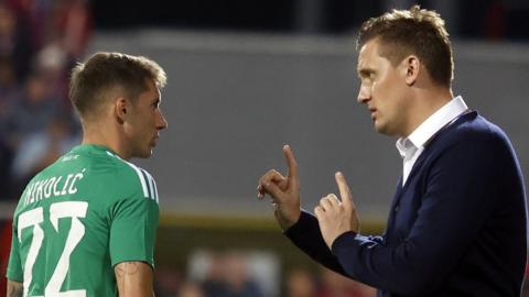 Aris Limassol player Veljko Nikolic with manager Aleksey Shpilevsky