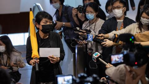 Pro-democracy lawmaker Claudia Mo Man-ching (L) arrives at the Legislative Council to tender her letter of resignation in Hong Kong, China, 12 November 2020