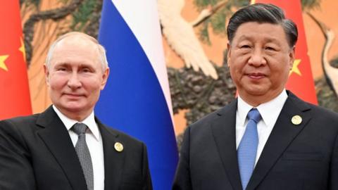 This pool photograph distributed by Russian state owned agency Sputnik shows Russia's President Vladimir Putin and Chinese President Xi Jinping posing during a meeting in Beijing on October 18, 2023.