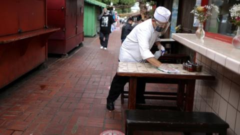 Baltazar Ayala, 54, cleans a dining table at La Noche Buena restaurant in Los Angeles, which is on the cusp of reopening parts of its economy if the county reaches 2 million coronavirus disease (COVID-19) vaccinations administered in disadvantaged areas, in Los Angeles, California, U.S., March 11, 2021.