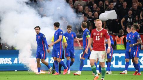 A flare is thrown on to the pitch during England's win over Hungary