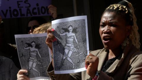 People shout slogans during a protest outside the courts of Aviles, after a Spanish court sentenced five men accused of the group rape of an 18-year-old woman on 27 April