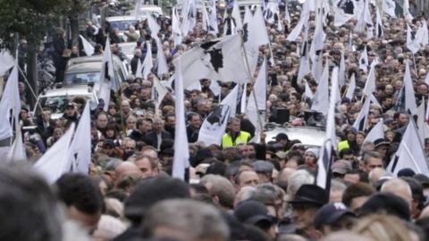 People hold flags during street protests in Ajaccio, Corsica on 3 February 2018.