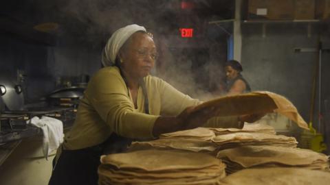 Zenebech Dessu prepares injera, an East African sourdough-risen flatbread at her Zenebech Restaurant in Shaw