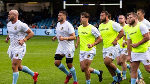 Exeter players warm up at Bath