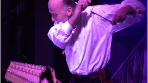 Damian Clarke playing a hammer dulcimer