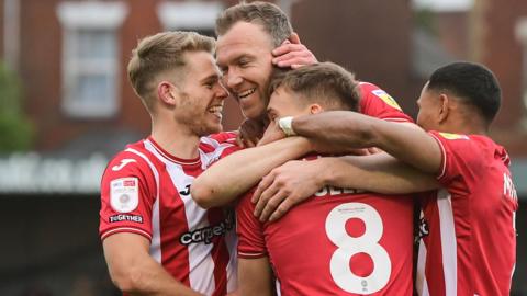 Exeter celebrate a goal by Kevin McDonald (second left)