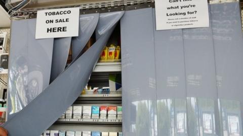 A shop with screens covering tobacco products