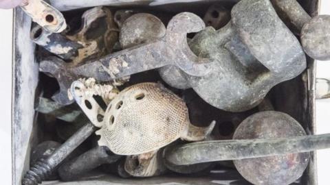 Metal items retrieved from a cremator