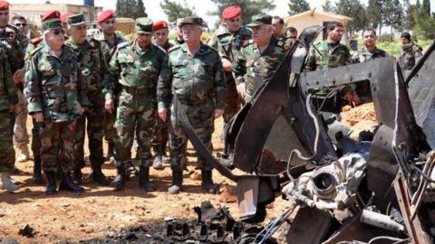 A handout photo of officials inspecting the damage in al-Shairat Air Base - 7 April 2017