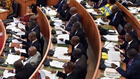 Ivory Coast's members of parliament examine the draft version of the new country constitution