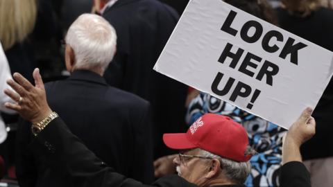 Man holding Lock Her Up sign