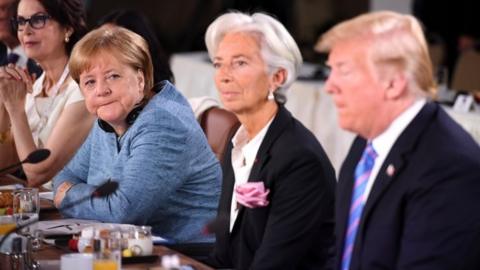 Angela Merkel looks at Donald Trump during G7 talks