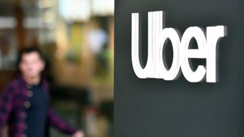 An Uber logo is seen on a sign outside the company's California headquarters