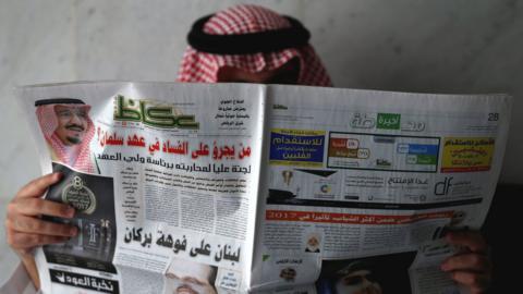 A Saudi man reads a newspaper in Riyadh that discusses the launch of an anti-corruption drive (5 November 2017)