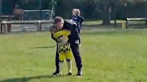 Dad embraces son on football pitch after first goal since cancer
