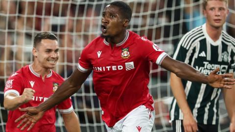 Aaron Hayden celebrates after scoring a goal for Wrexham