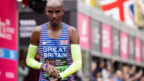 Mo Farah crosses the finish line at the London Marathon for the final time