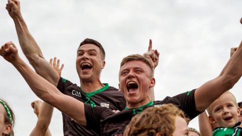 Mark Kelly and Jamie Gribbin celebrate after Cargin clinch their seventh Antrim title in nine seasons