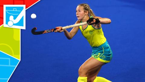 An Australian hockey player controls the ball