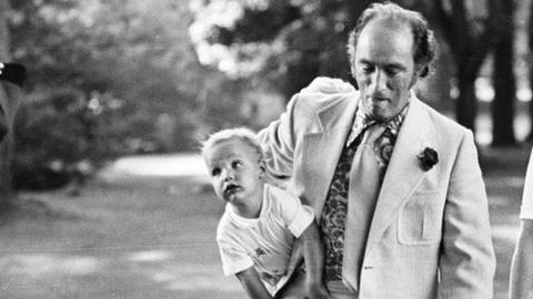 A young Justin Trudeau rests on his father's hip, 1973