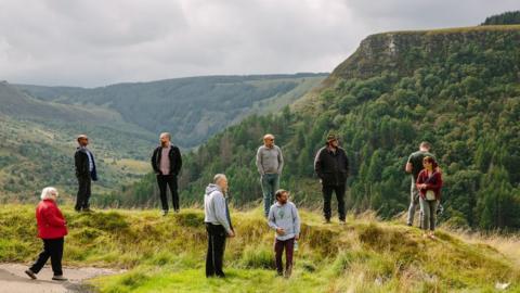 People from Welcome to the woods standing on a ridge
