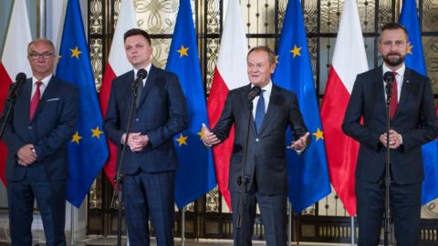 Opposition party leaders, from left, Wlodzimierz Czarzasty, Szymon Holownia, Donald Tusk and Wladyslaw Kosiniak-Kamysz announce to the media that Tusk is their candidate for prime minister